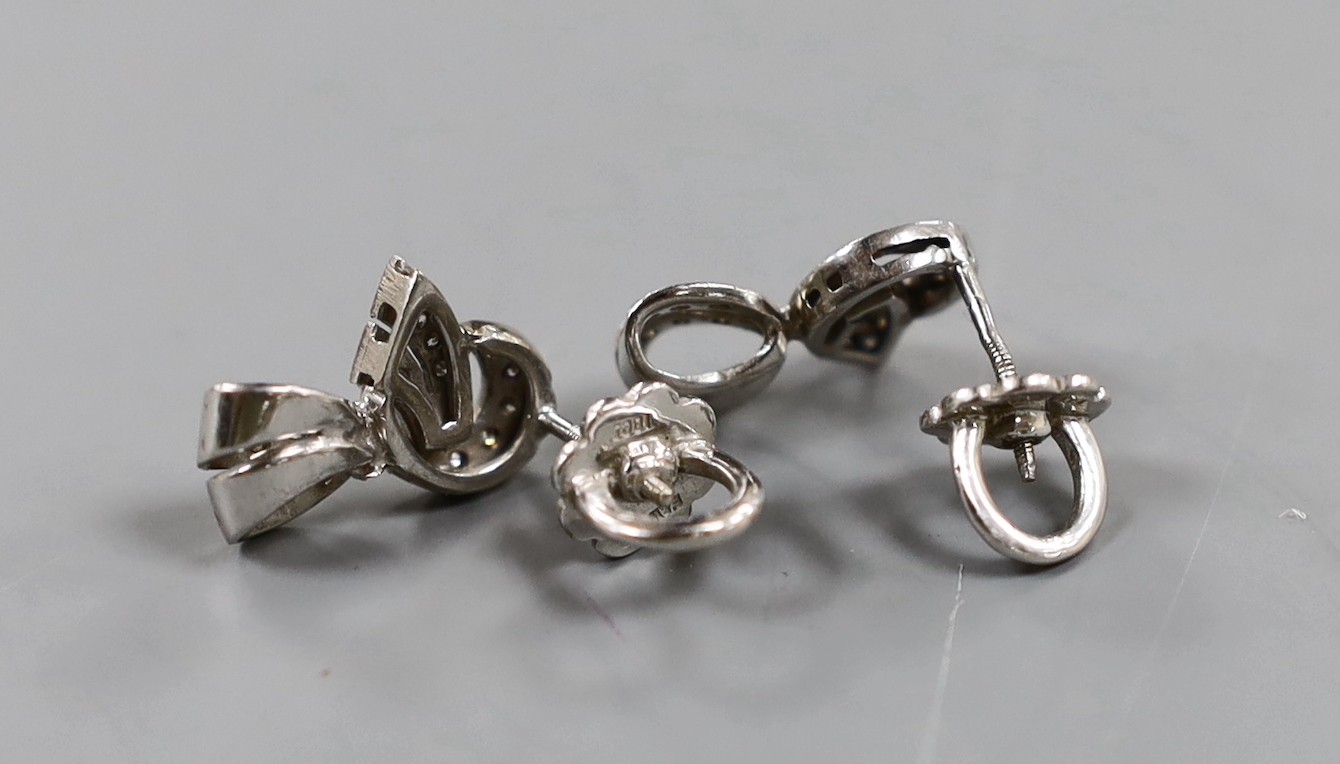 A modern pair of 18ct white gold and diamond chip set scroll earrings, 17mm, gross weight 6.8 grams.